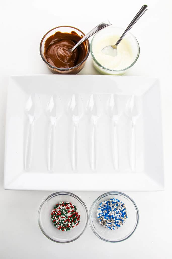 Ingredients for hot chocolate spoons with melted chocolate in bowls