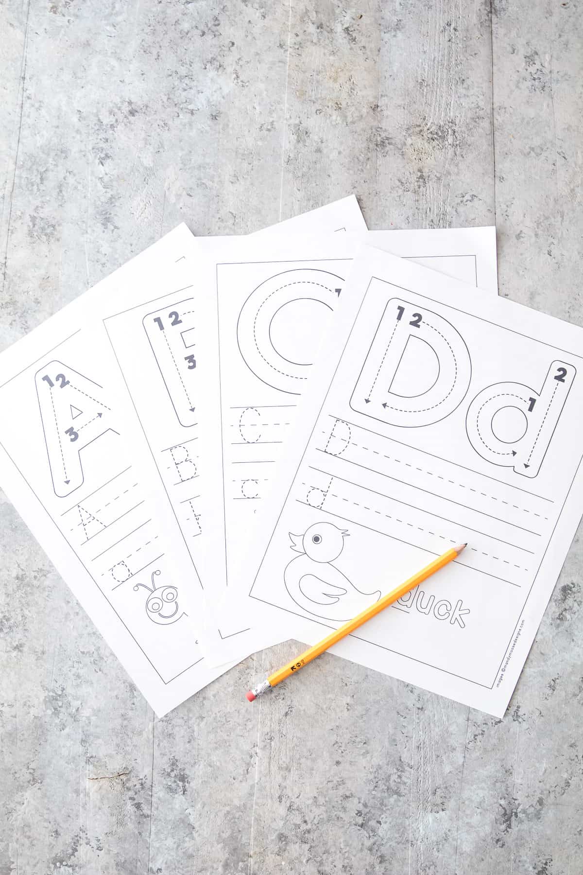 Set of 4 Letter Tracing Worksheets with a pencil