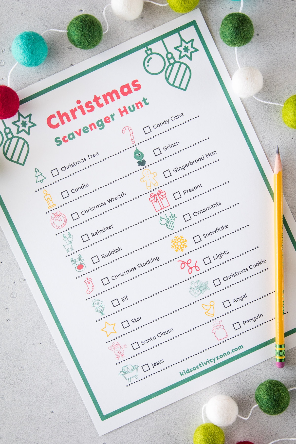 Christmas Scavenger Hunt Printable laying on table with pencil