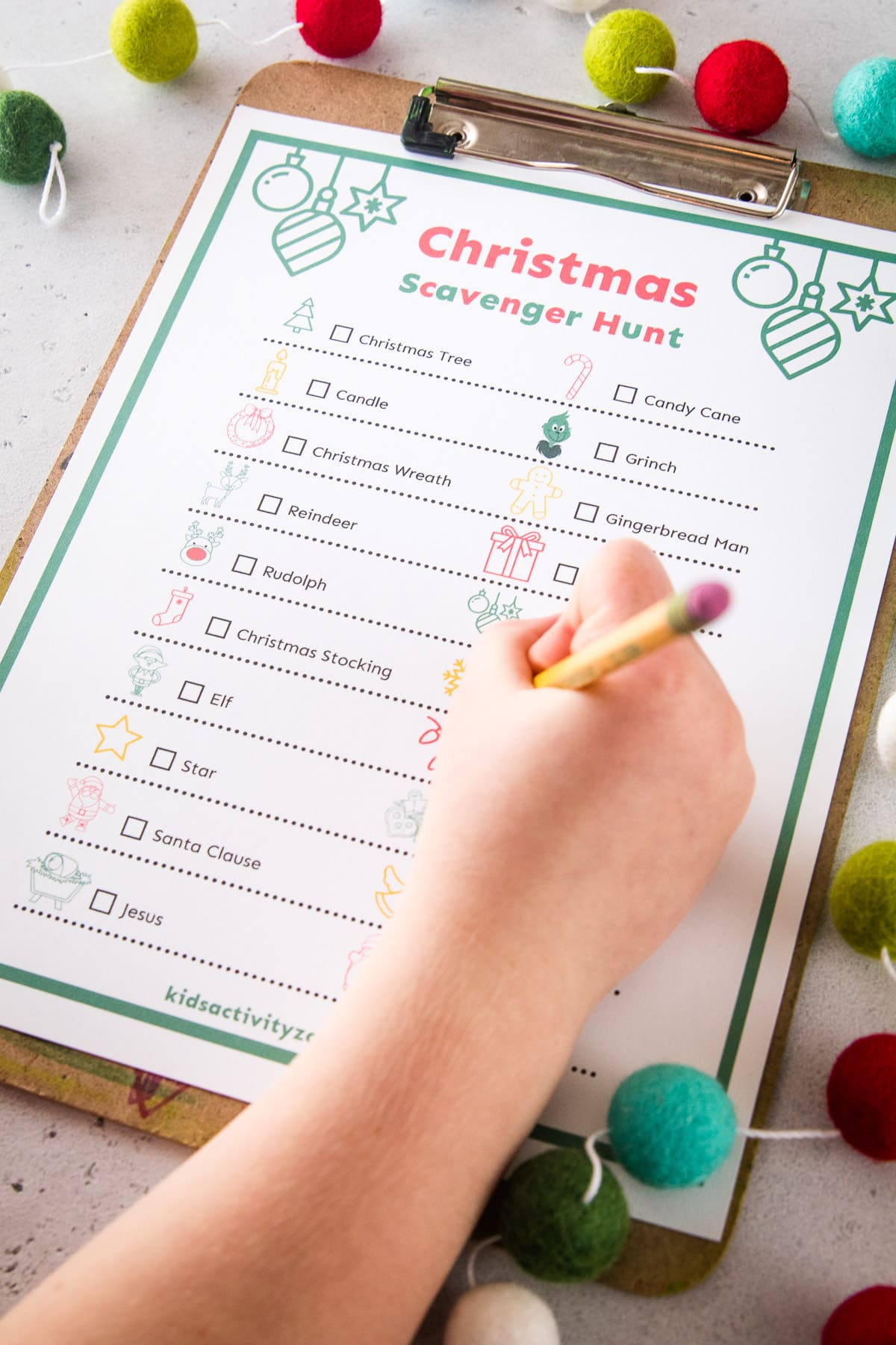 Child filling out Christmas Themed Scavenger Hunt