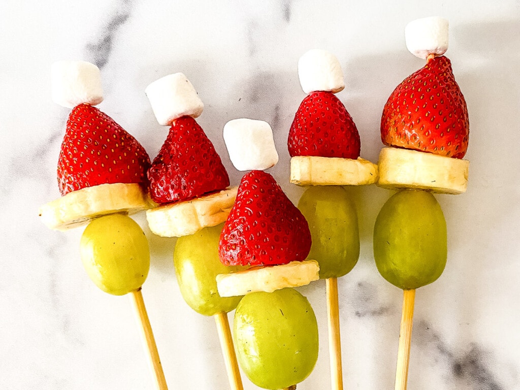 Grinch Fruit Kabobs on marble background