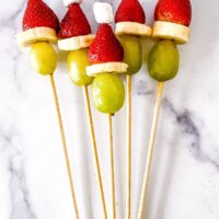 Skewers threaded with grapes, bananas, strawberries and marshmallows