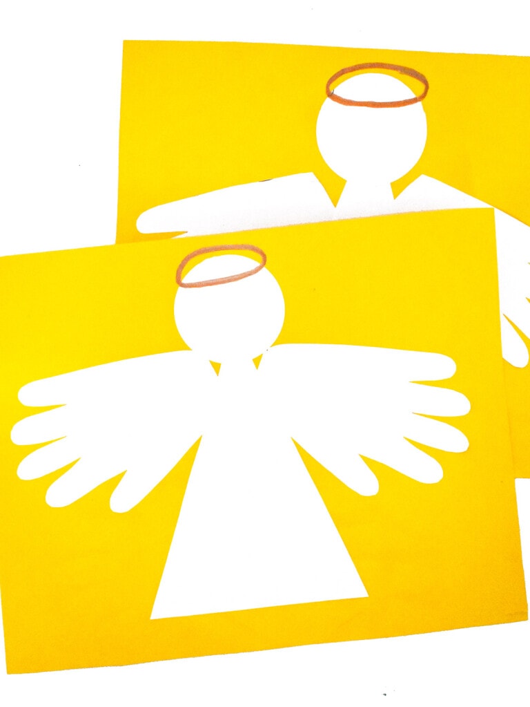 Image of two finished Handprint Angel Craft on yellow paper