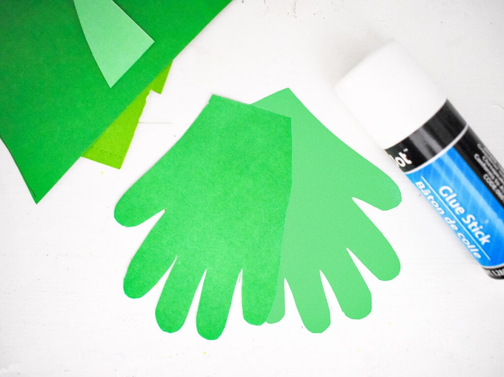 Two handprints cut out of green cardstock glued together