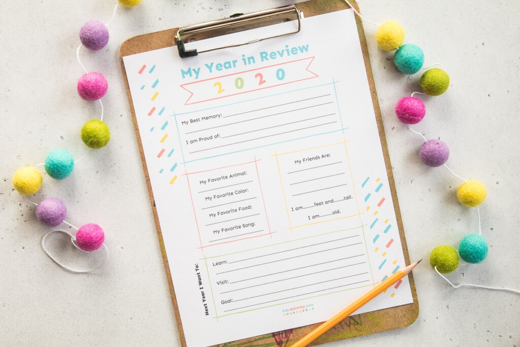 My Year in Review Printable on a clipboard with pom poms