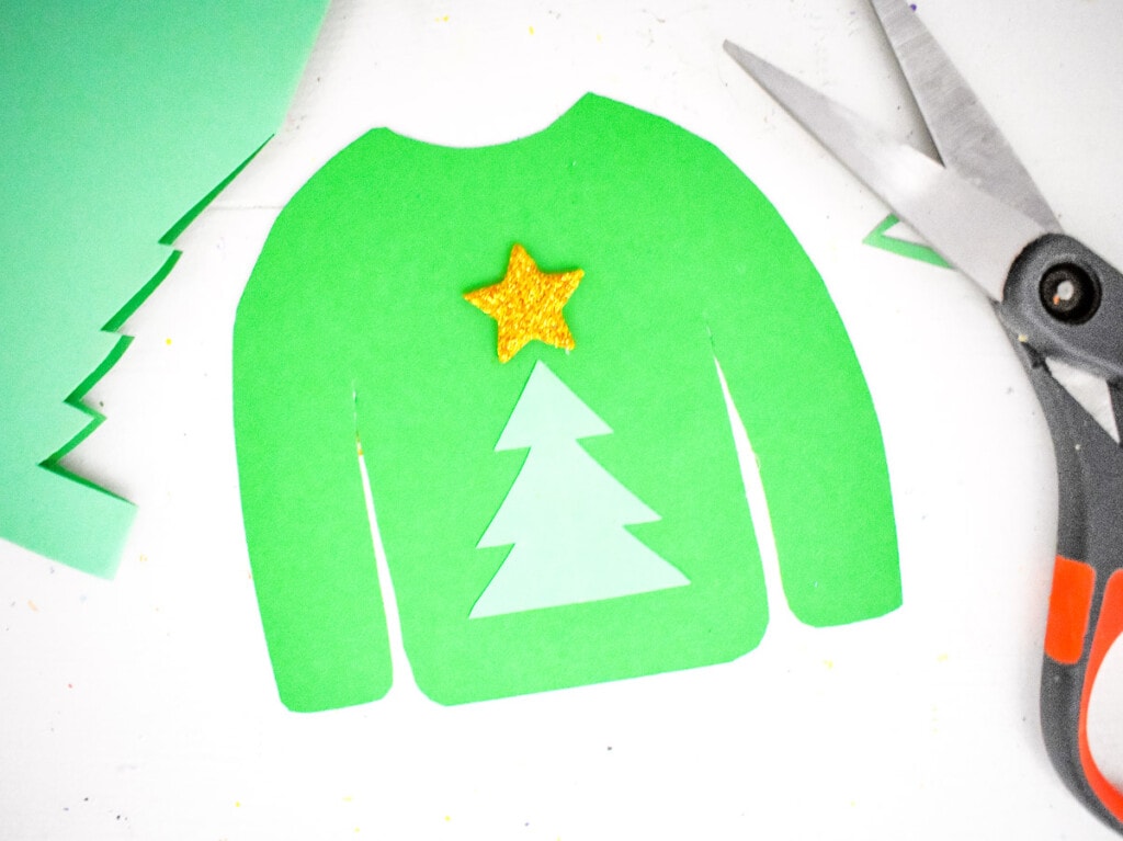 Green sweater with a gold star and christmas tree