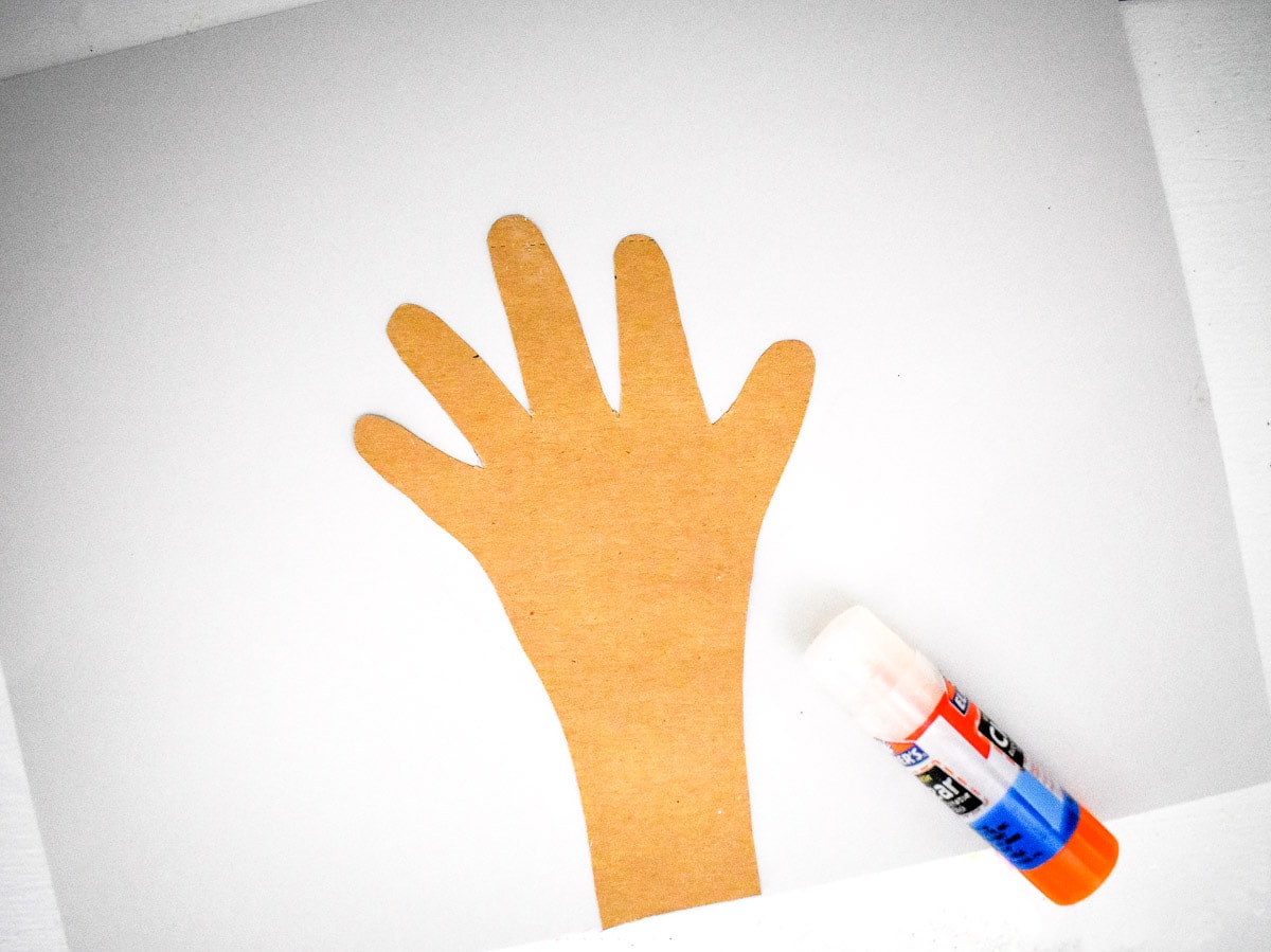 Brown handprint glued to white paper