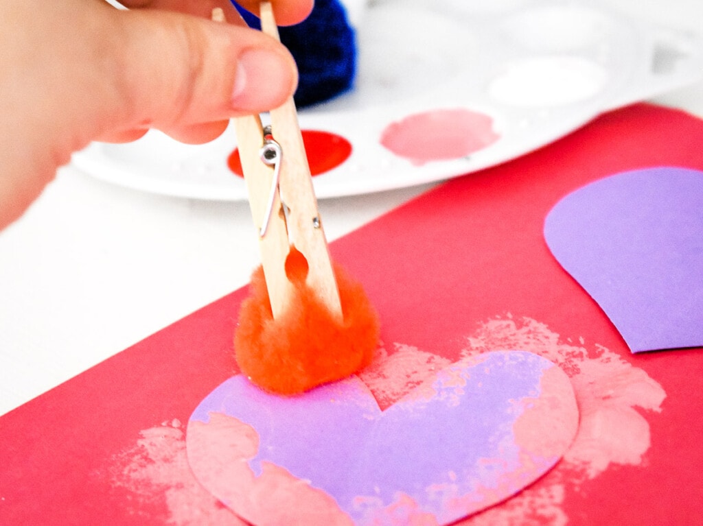 Clothespin painting over a heart cut out