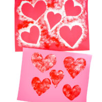 Two finished Pom Pom Heart Paintings on white background