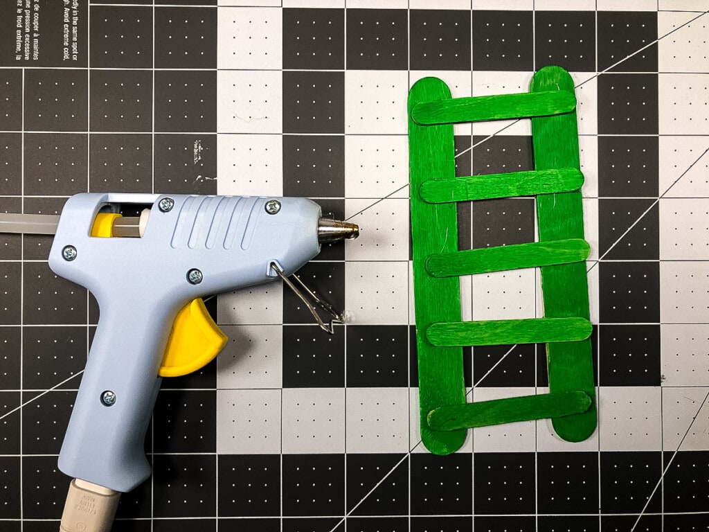 Making a green ladder out of popsicle sticks