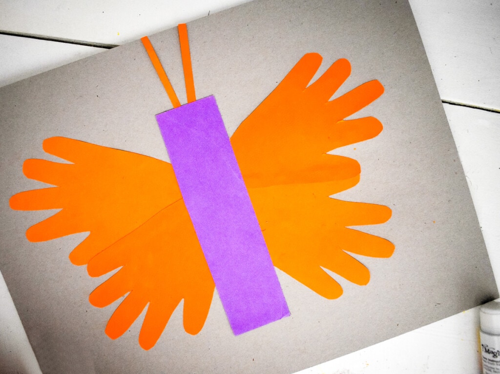 Assembling butterfly out of handprints on paper