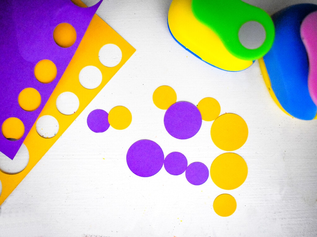 Punching yellow and purple circles out of paper