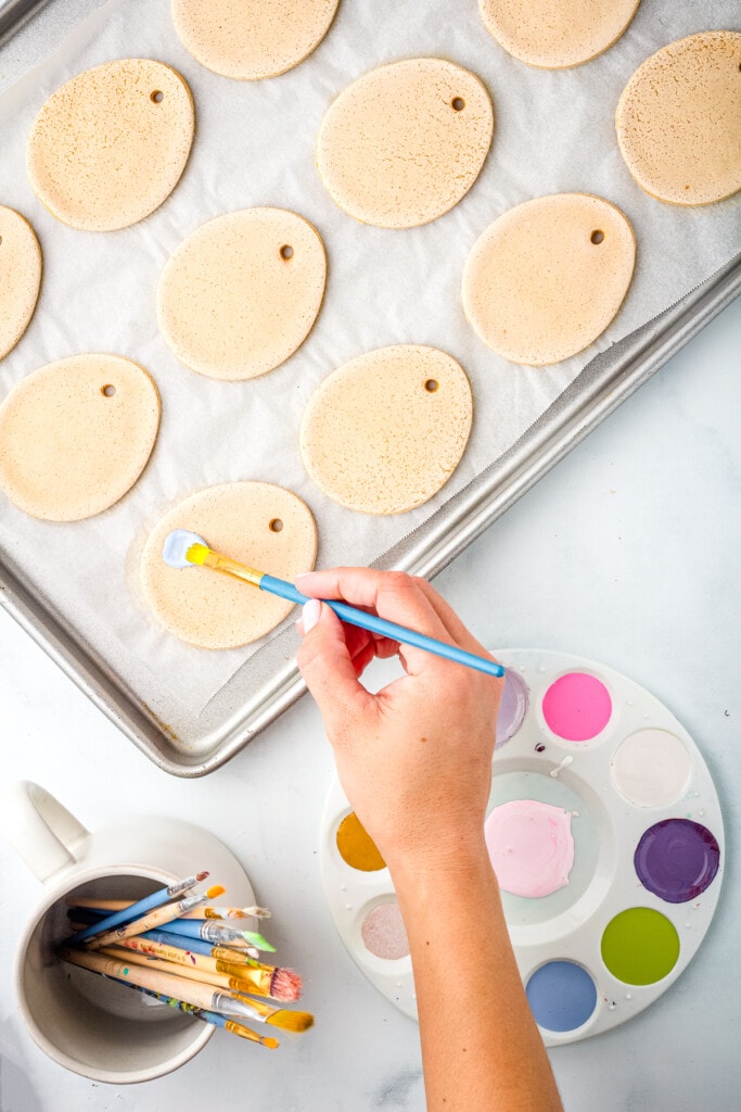 Hand painting Salt Dough Easter Eggs with paint brush