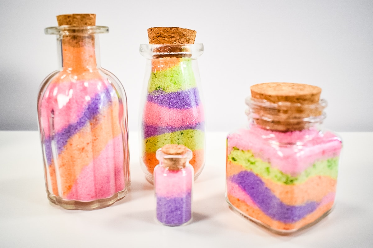 Colored Salt Jars lined up on white background