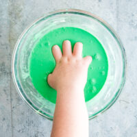 Hand in green oobleck