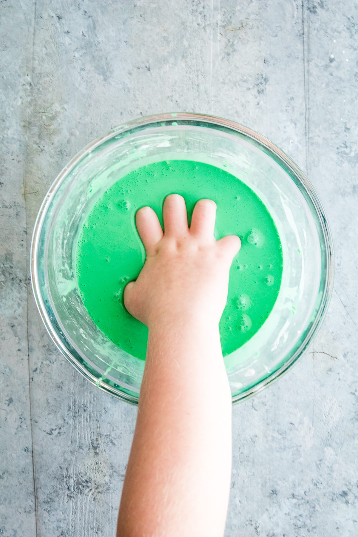 Hand in green oobleck