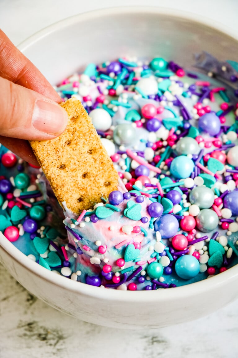 Dipping a graham cracker into Mermaid Dip