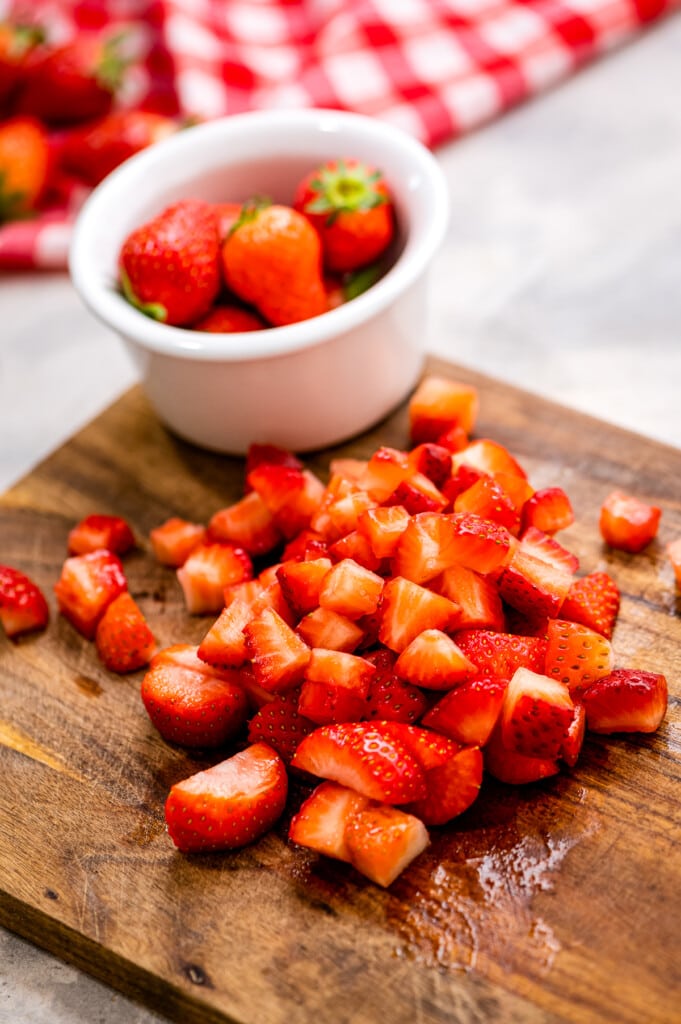 Chopped up strawberries on cutting board
