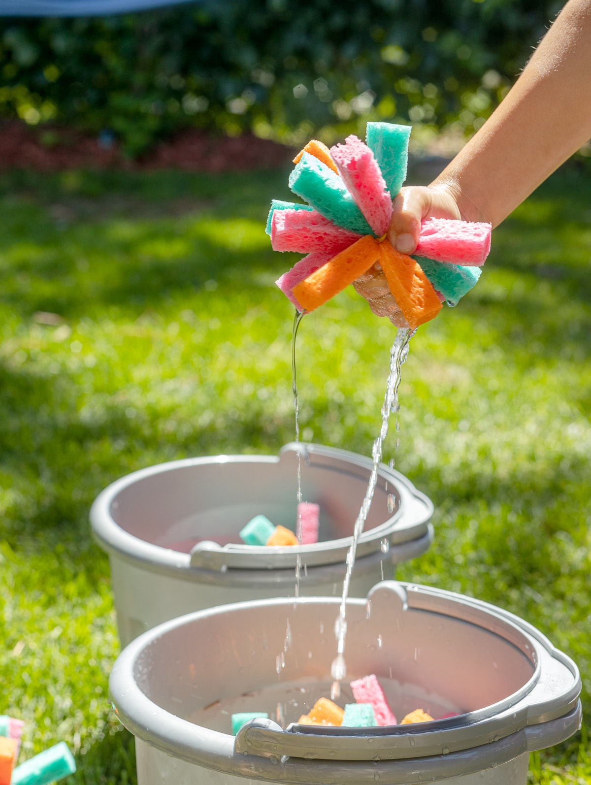 Hand squeezing a reusable sponge water bomb