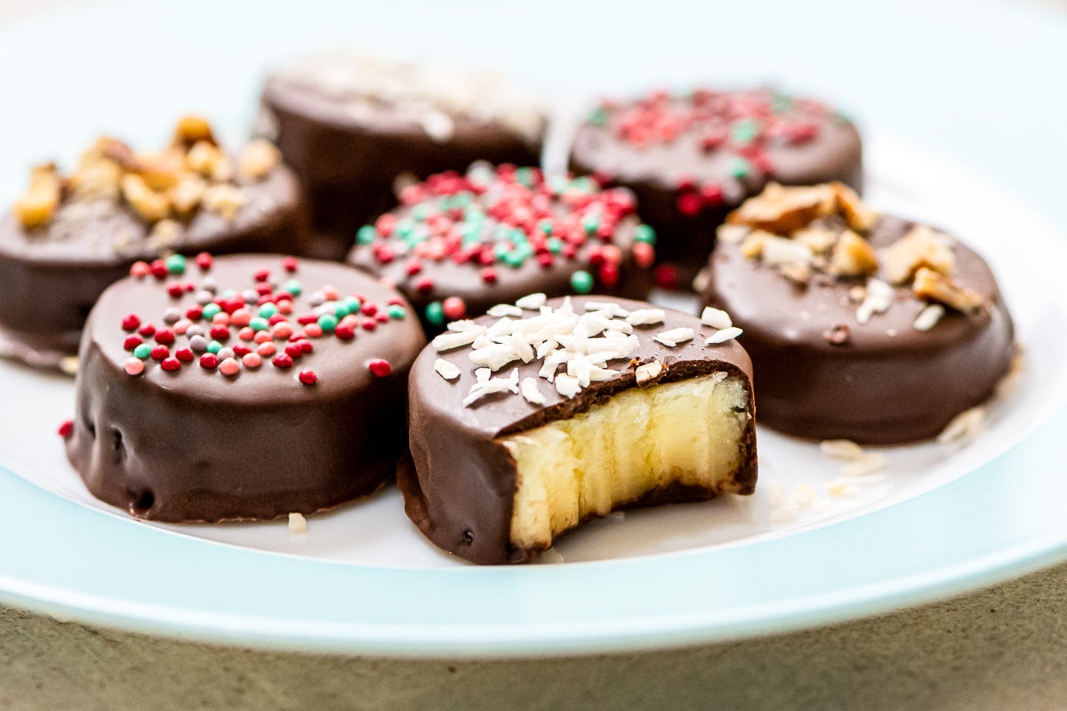 Chocolate Banana Pieces on blue plate with one banana bite gone