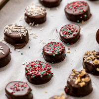 Parchment paper lined baking sheet with chocolate dipped banana slices
