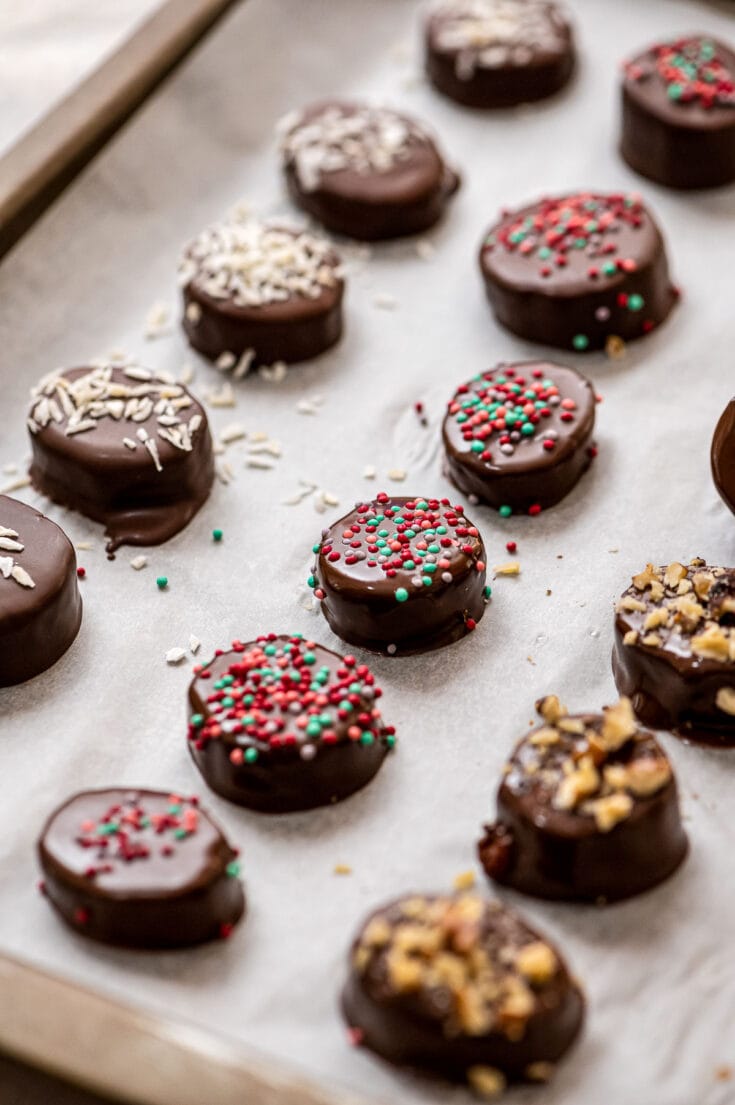 Parchment paper lined baking sheet with chocolate dipped banana slices