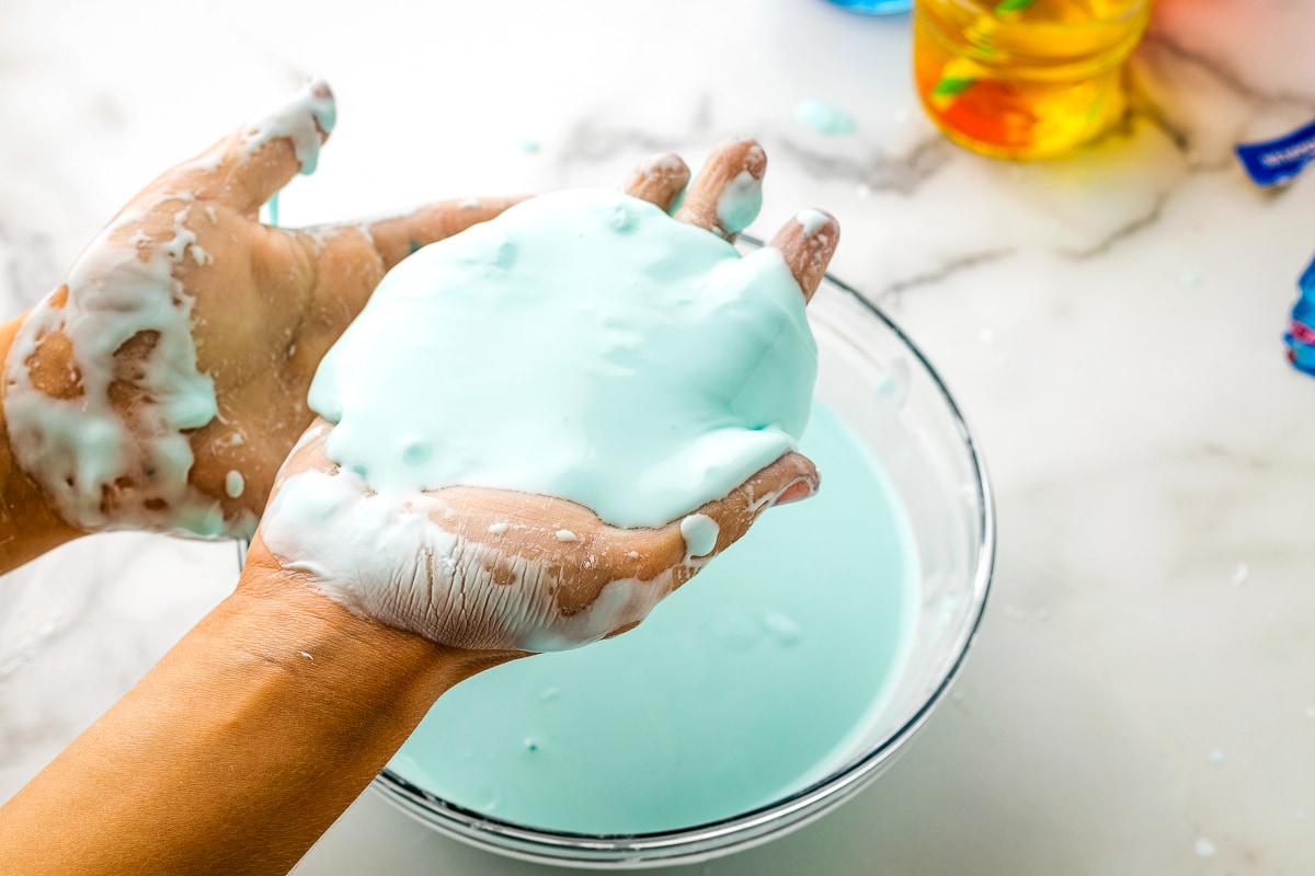 Hand with blue oobleck on it