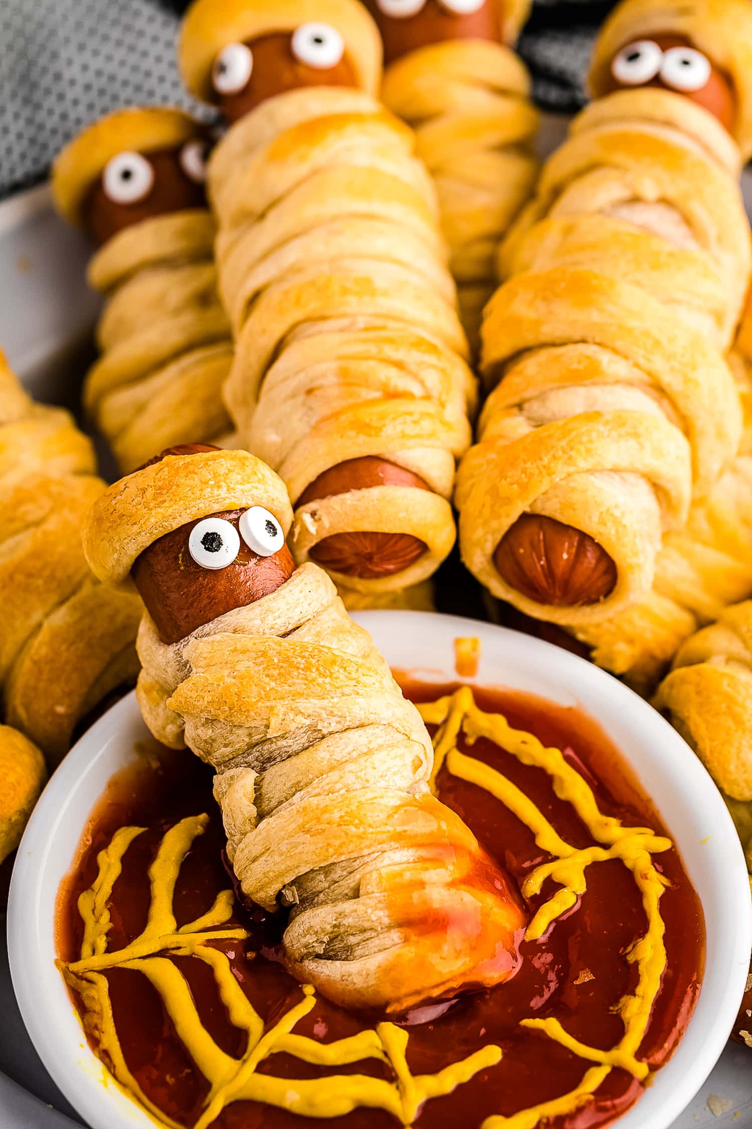 Mummy Hot Dog dipped in ketchup