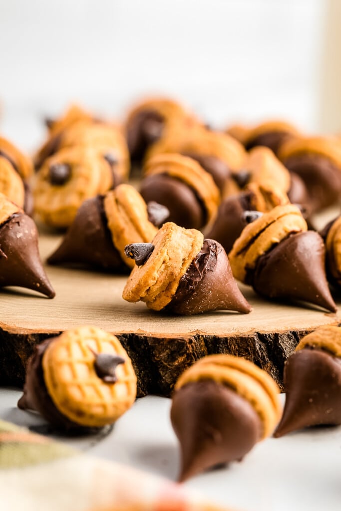 Nutter Butter Acorns laying on a piece of wood tree stump