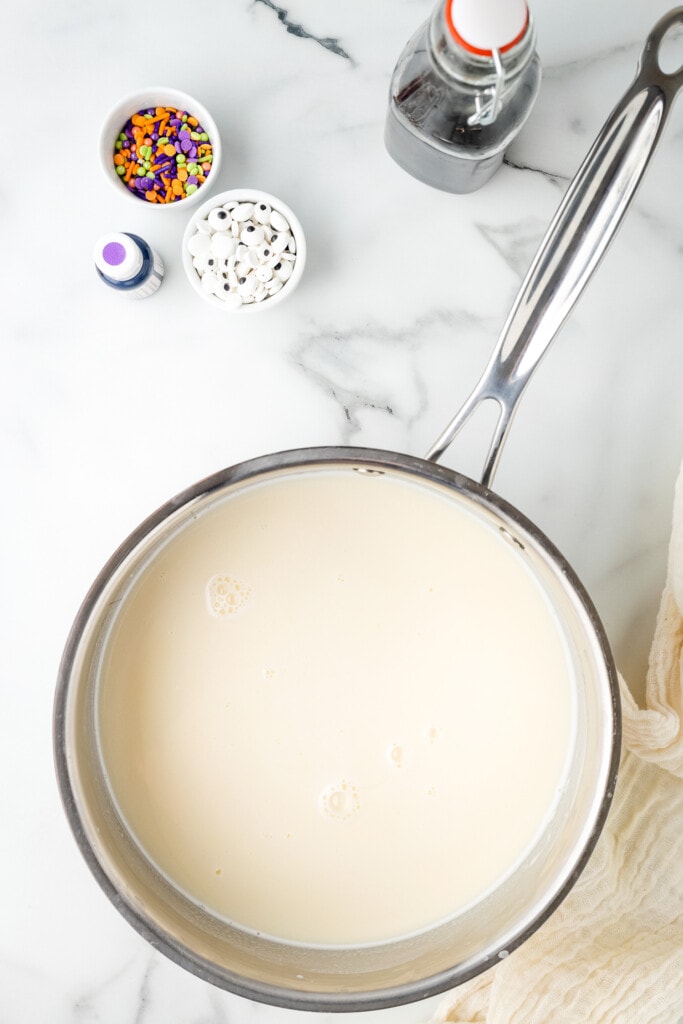 Overhead image of melted white chocolate chips and milk in saucepan