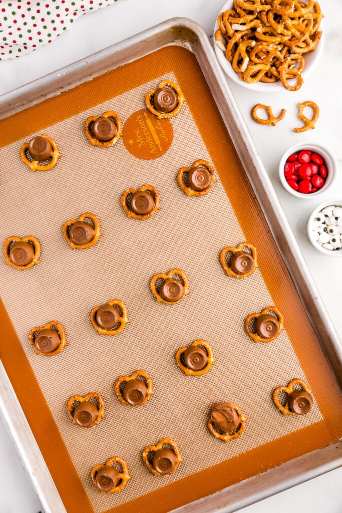 Overhead image of baking sheet of pretzel twists with a melted Rolo