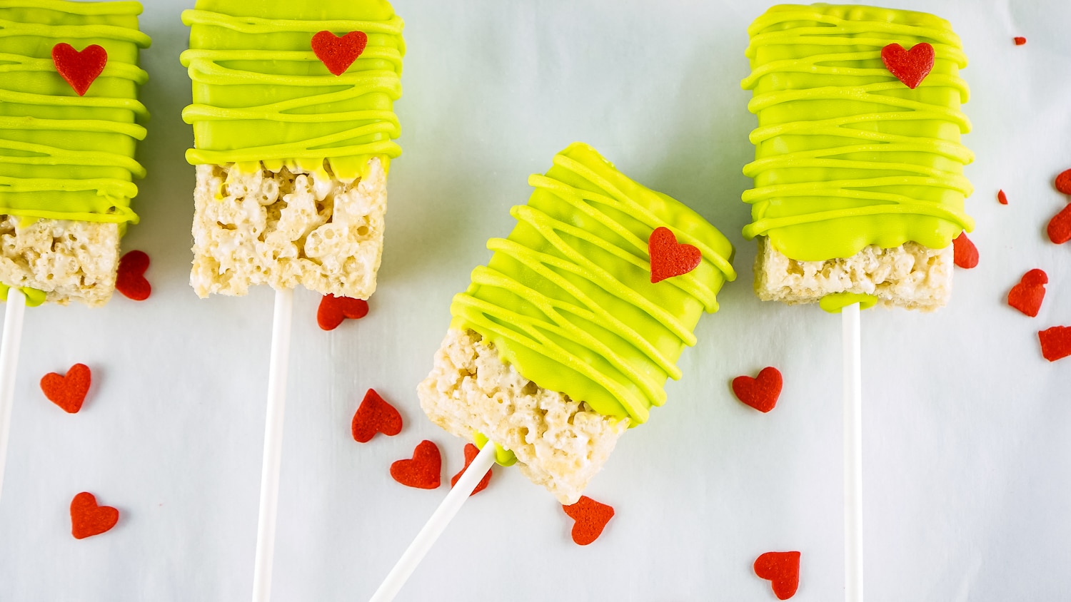 Grinch Rice Krispies Treats laying on waxed paper