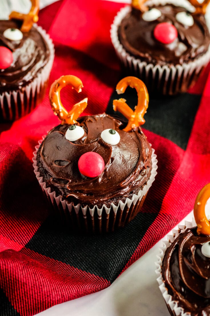 Red and black napkin with reindeer cupcake on it