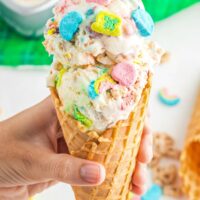 Hand holding a cone with lucky charms ice cream