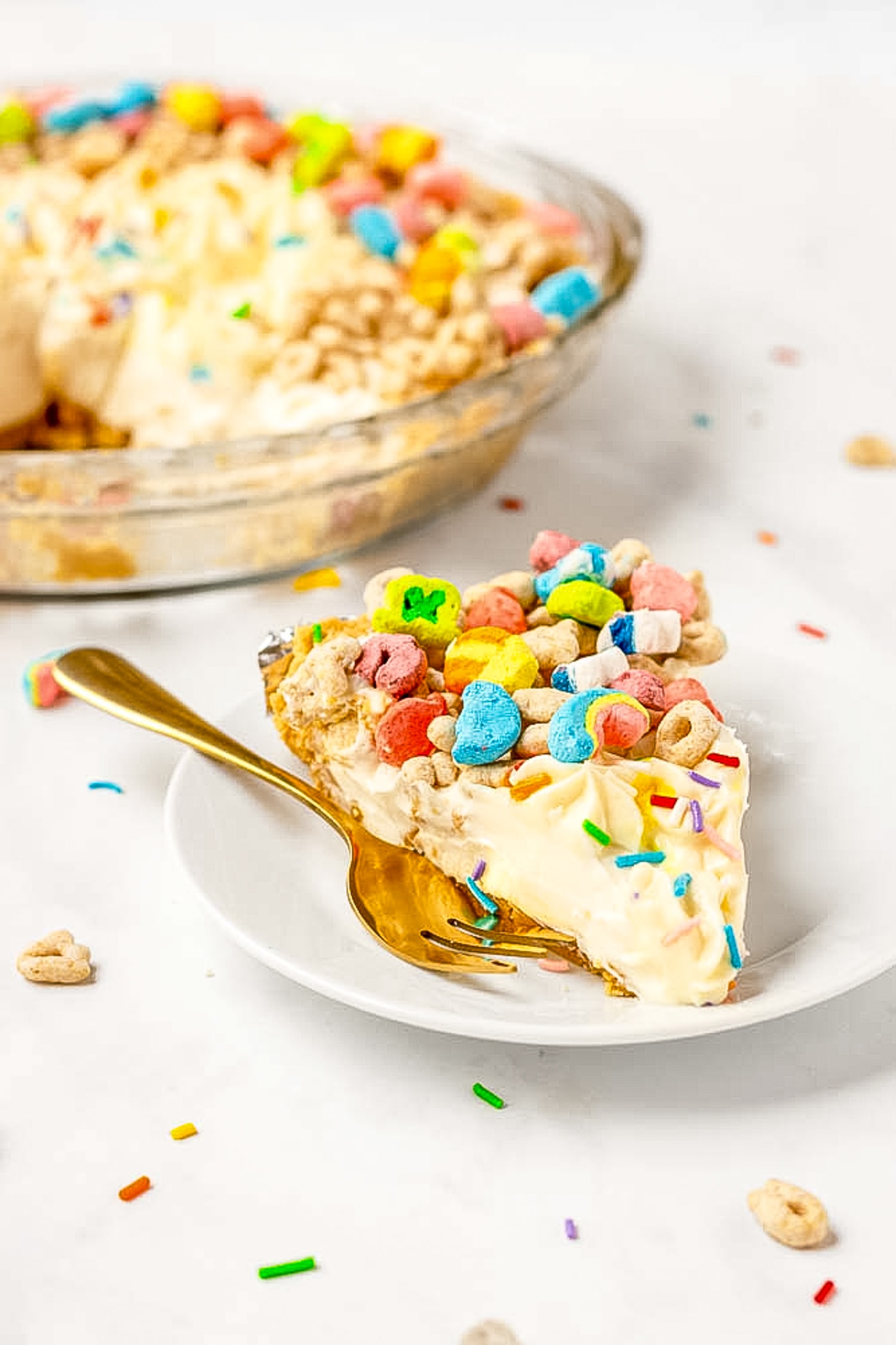 Slice of Lucky Charms Pie on white plate with fork