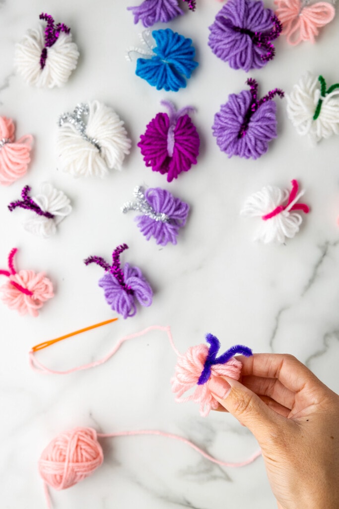 Holding a yarn butterfly for garland