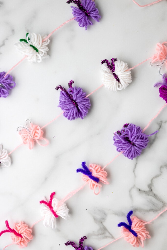 Yarn Butterfly Garland on marble background