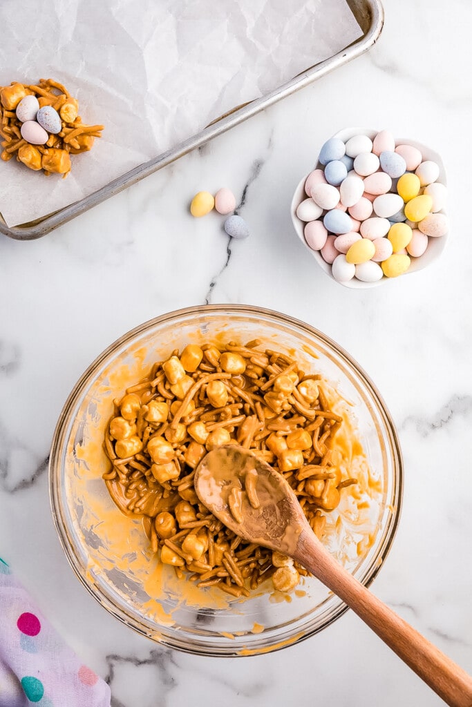 Glass bowl with melted butterscotch chips, peanut butter, marshmallows and chow mein noodles