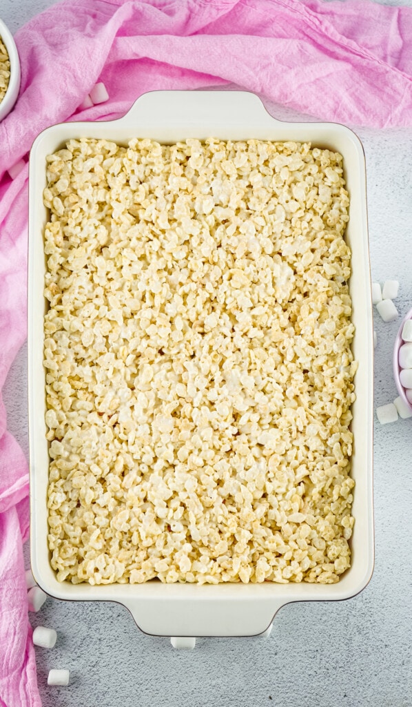 White casserole dish with a layer of rice krispies treats