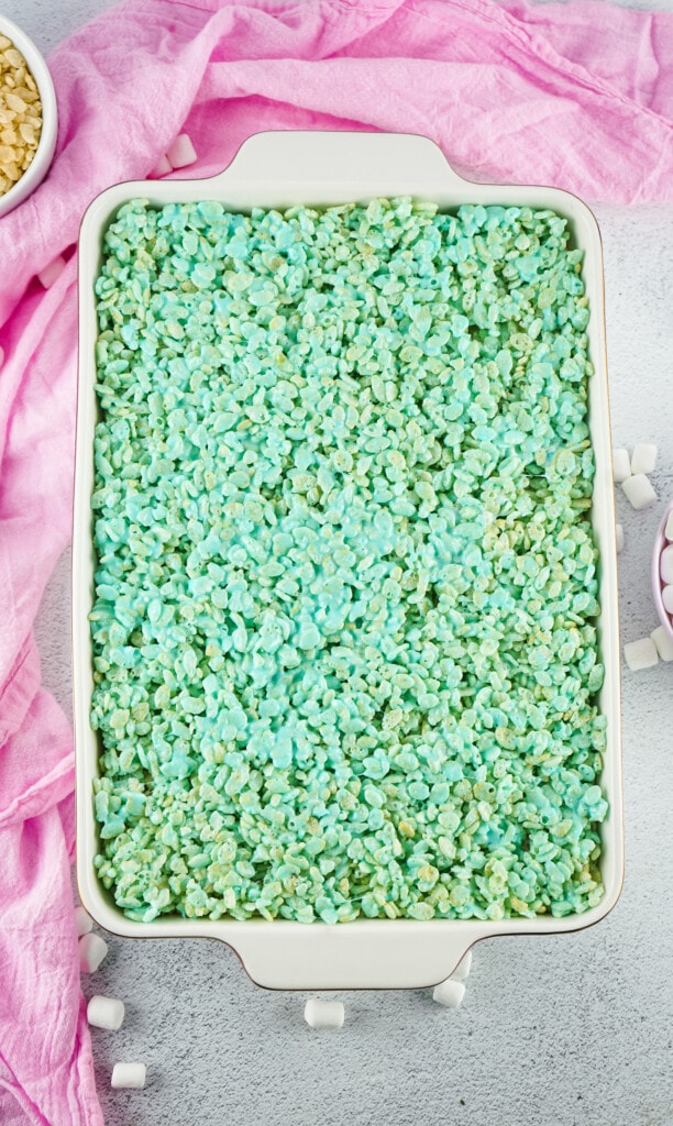 White casserole dish with a layer of green rice krispies treats