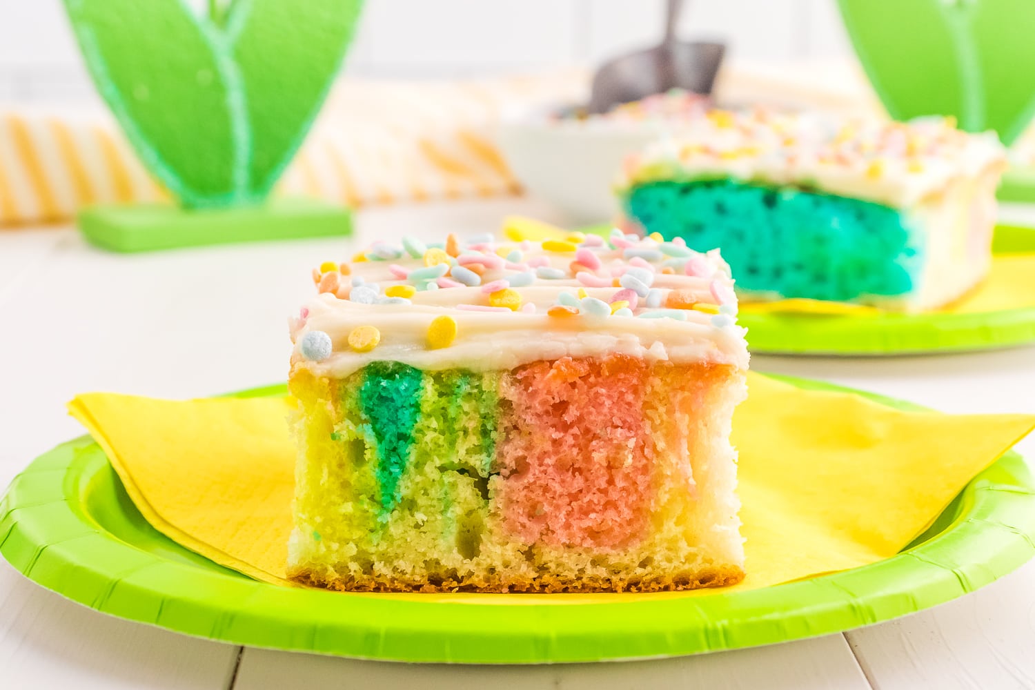 Piece of spring swirled cake on green paper plate