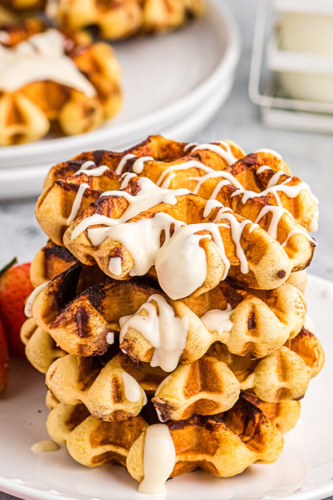Cinnamon Roll Waffles stacked topped with cream cheese glaze