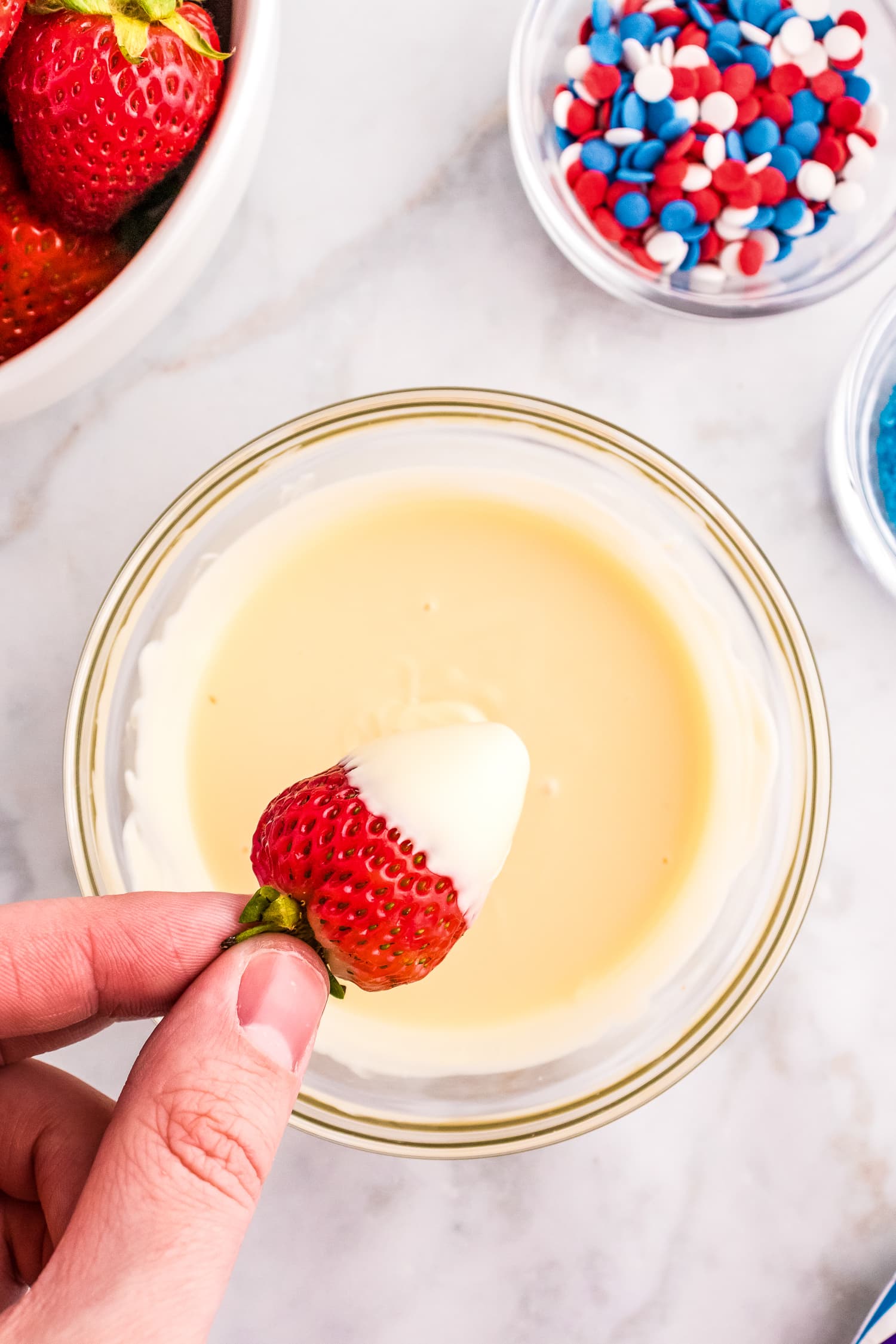 Dipping strawberry in white chocolate