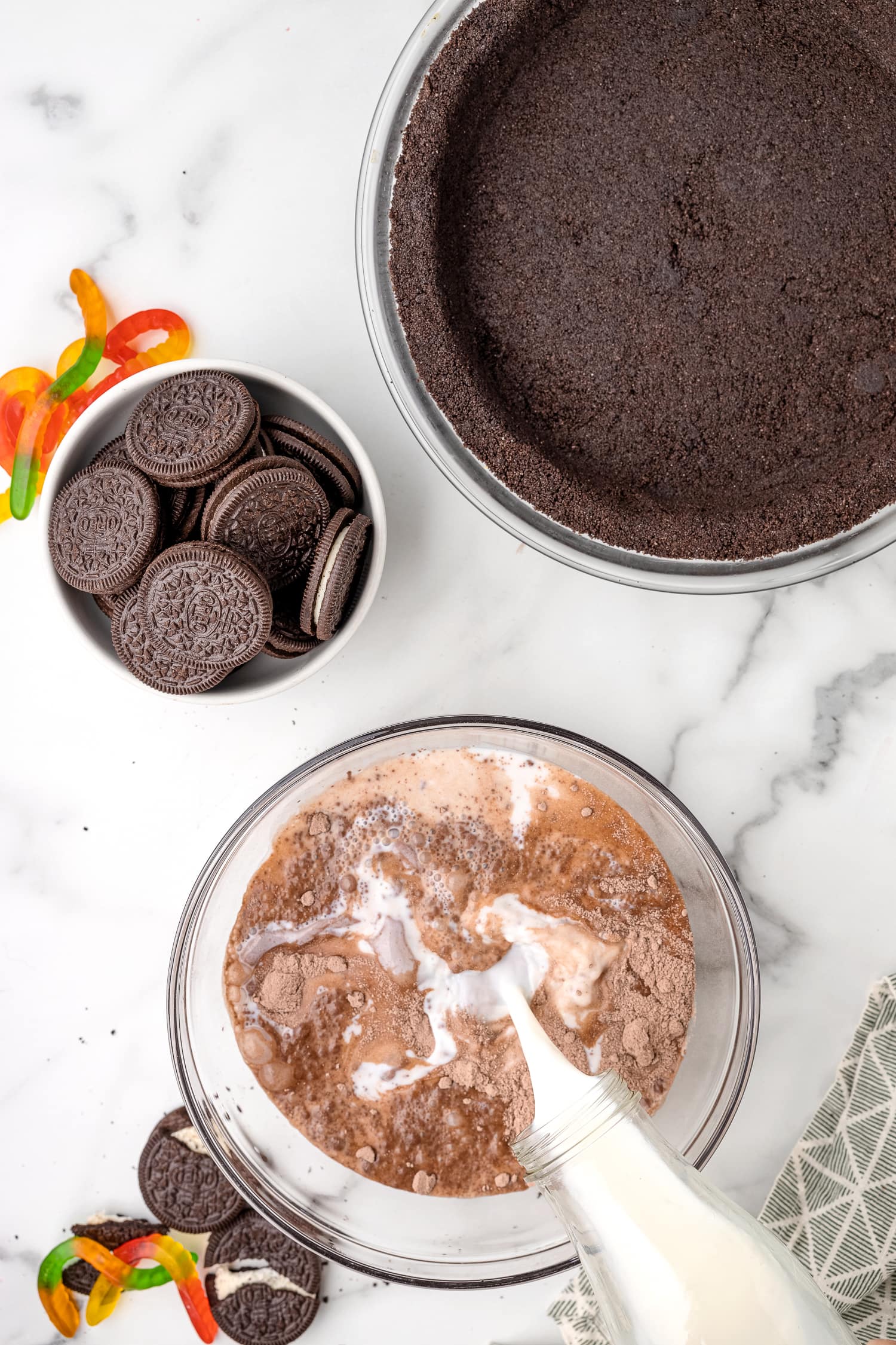 Adding milk to chocolate pudding mix.