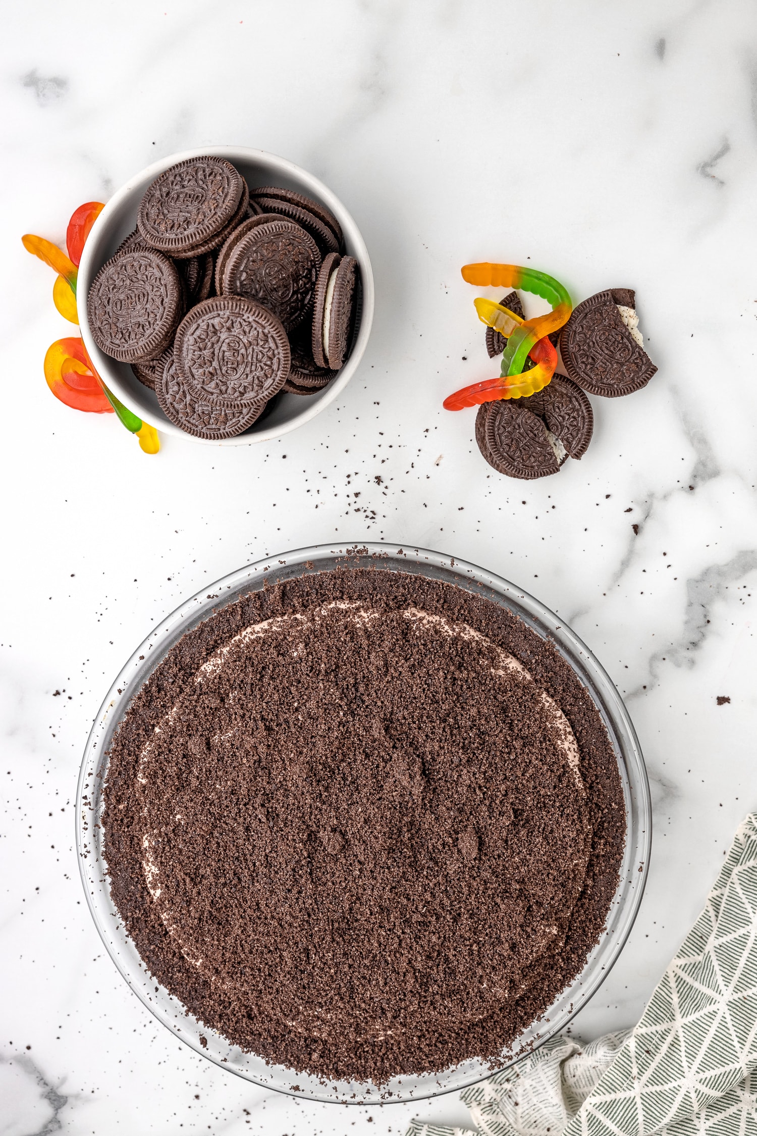 Topping pie with crushed Oreos.