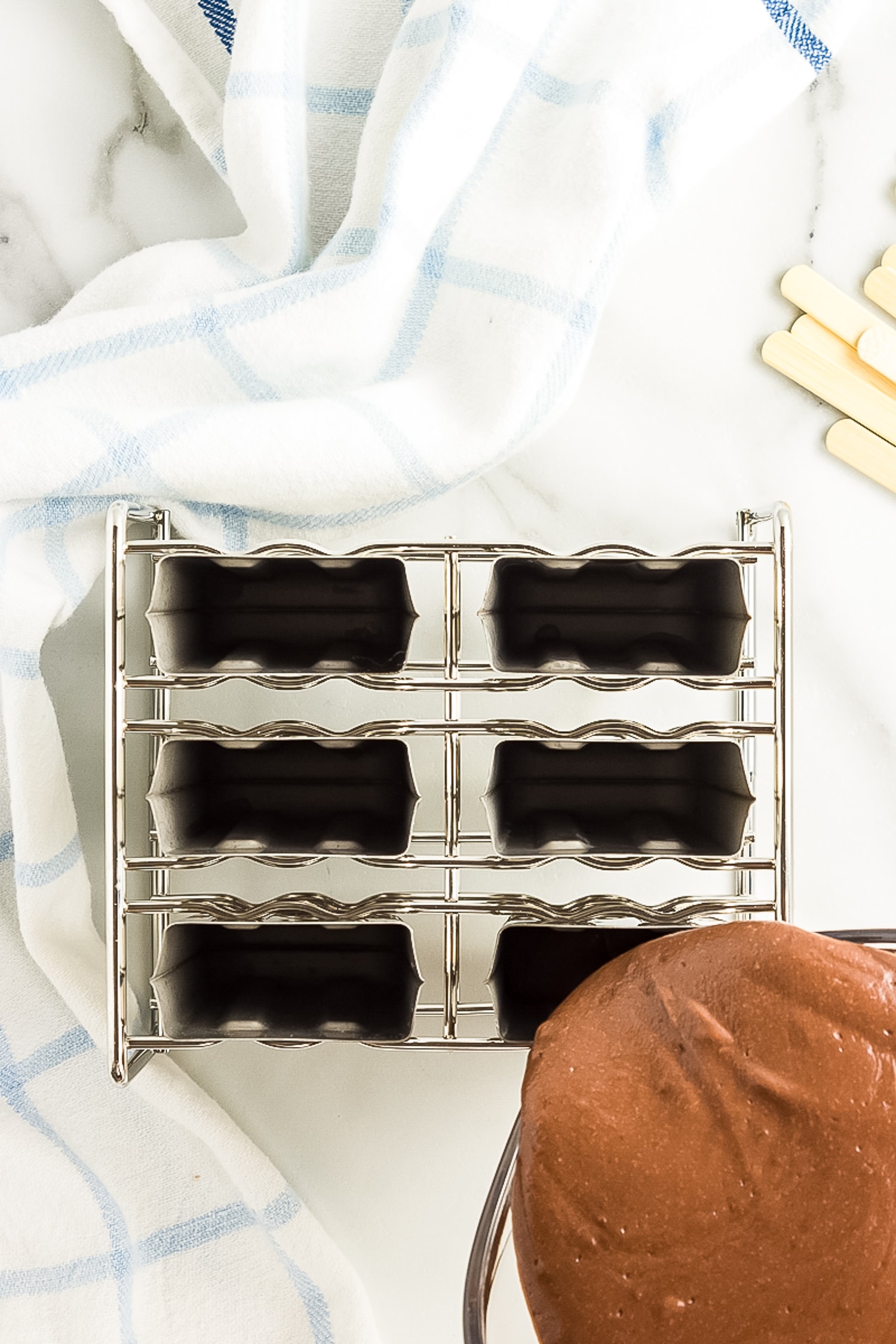 Pouring fudgesicle mix into popsicle mold