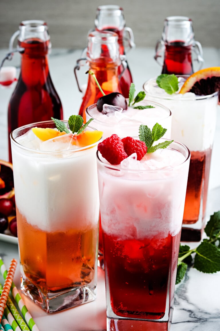 Three glasses of Italian Soda and garnishes.