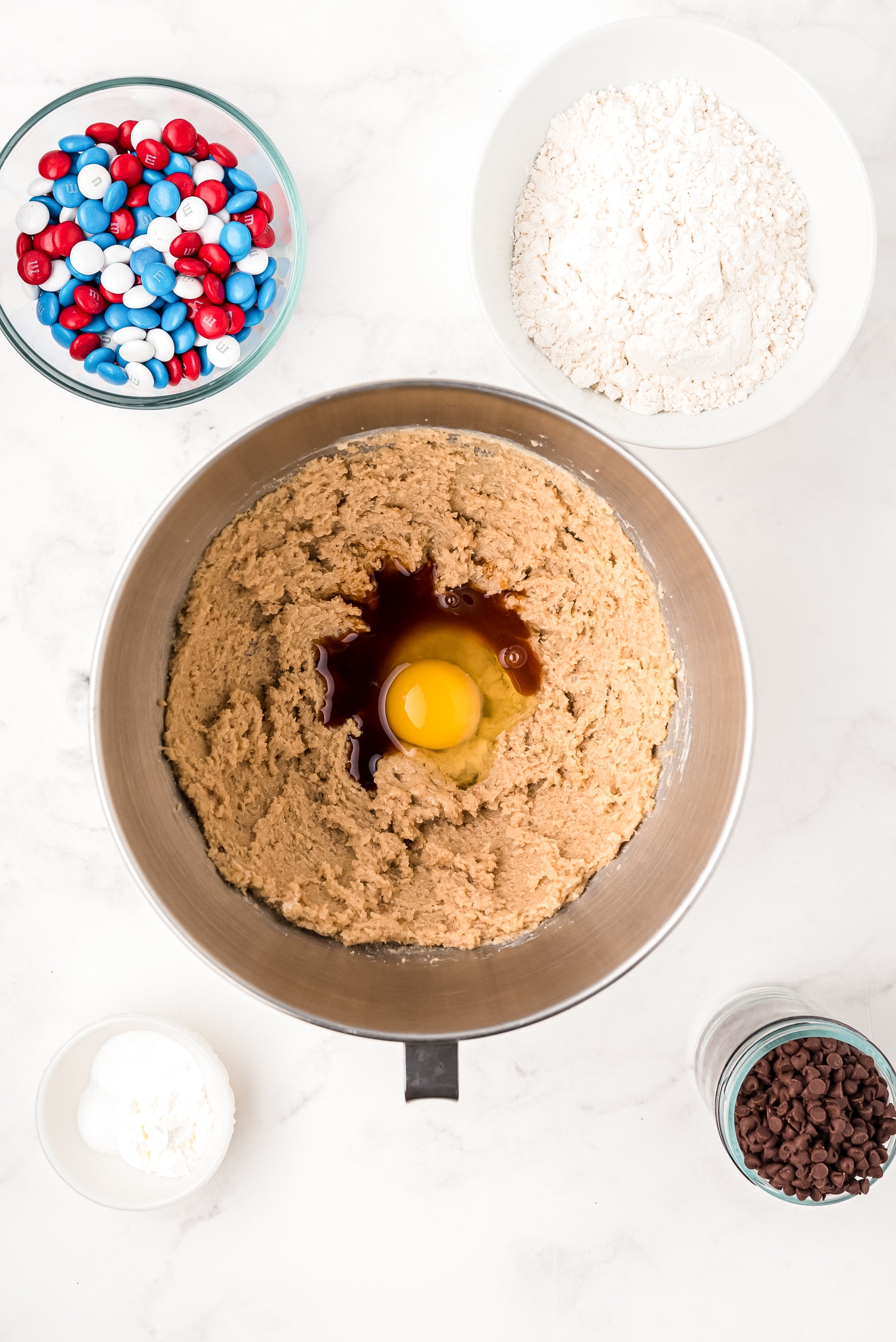 Mixing bowl adding eggs and vanilla to cookie dough