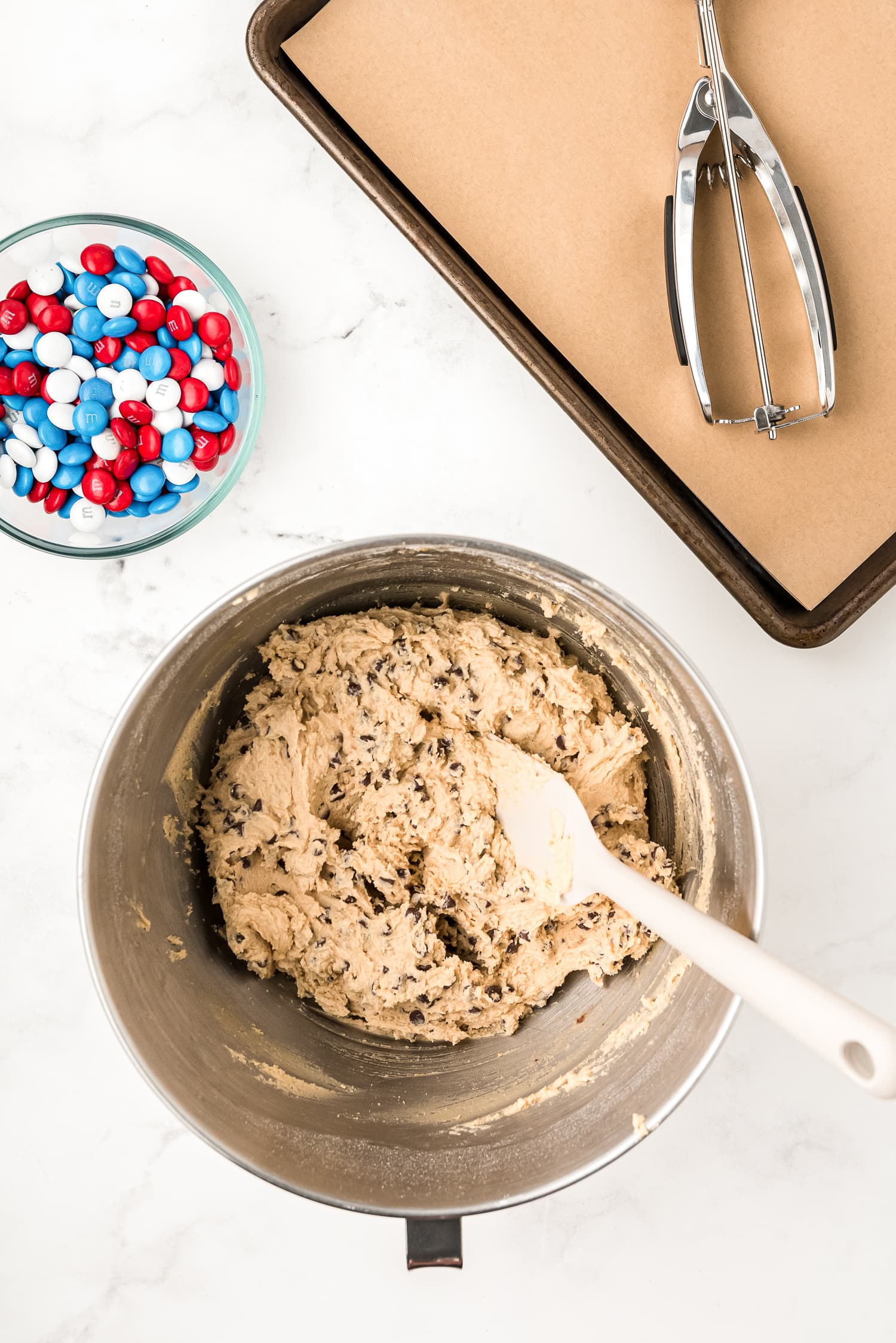 Cookie dough with mini chocolate chips in mixing bowl