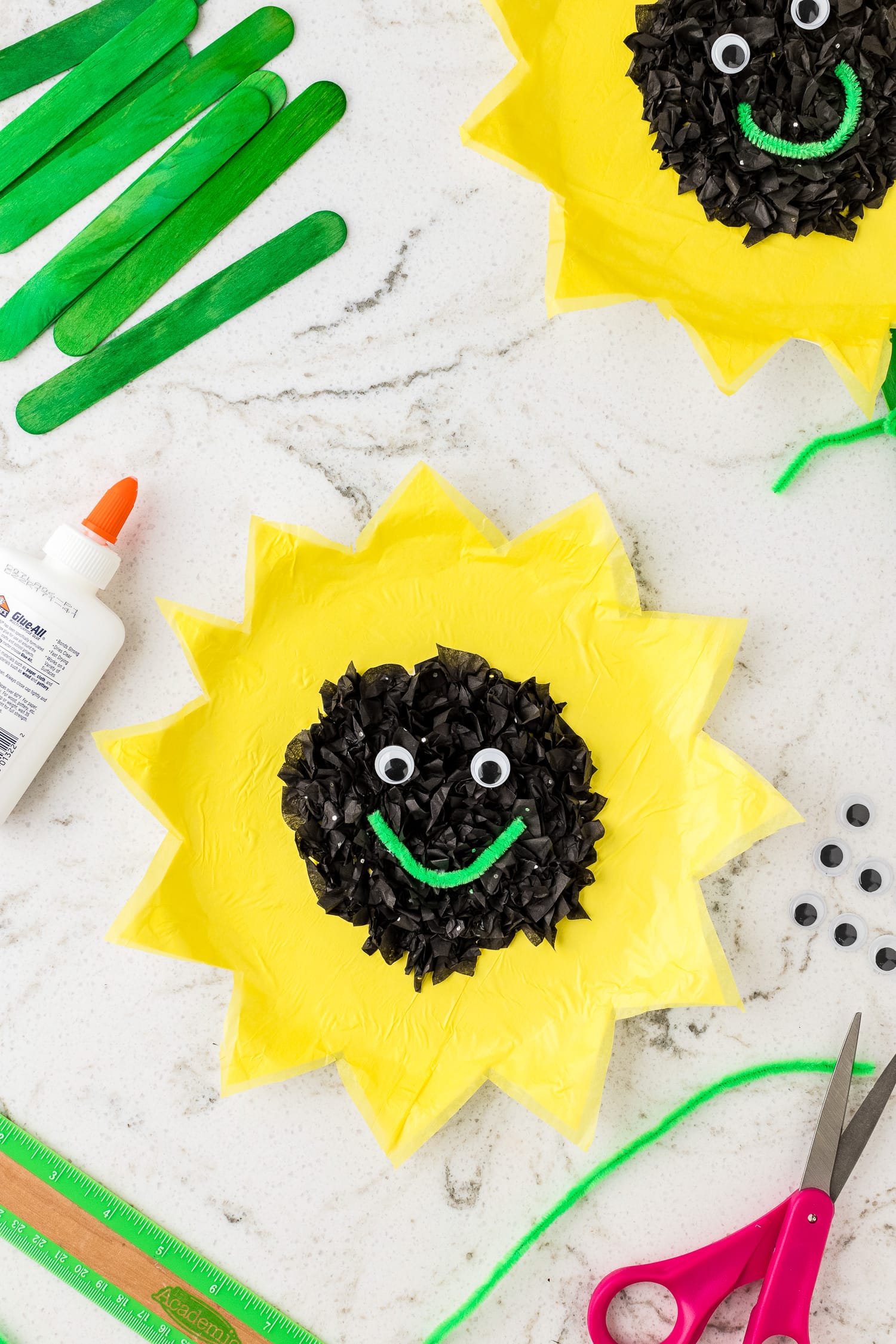 Sunflower paper plate with googly eyes and green smile